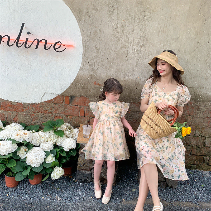 Matching summer dress for mother and daughter with a floral pattern and short puff sleeves