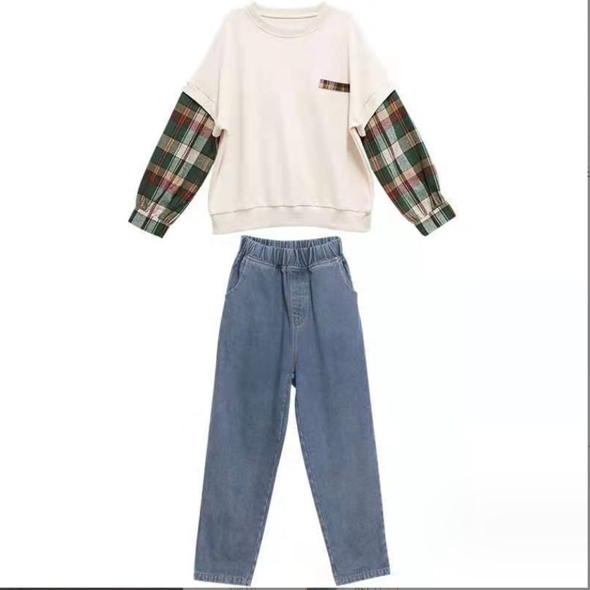 A two-piece set for girls, a white T-shirt-style sweater with long sleeves in a check pattern and denim pants.