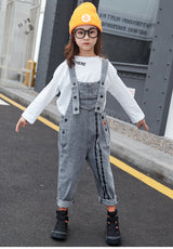 An elegant denim jumpsuit decorated with black buttons and two black longitudinal stripes with a white long-sleeved shirt