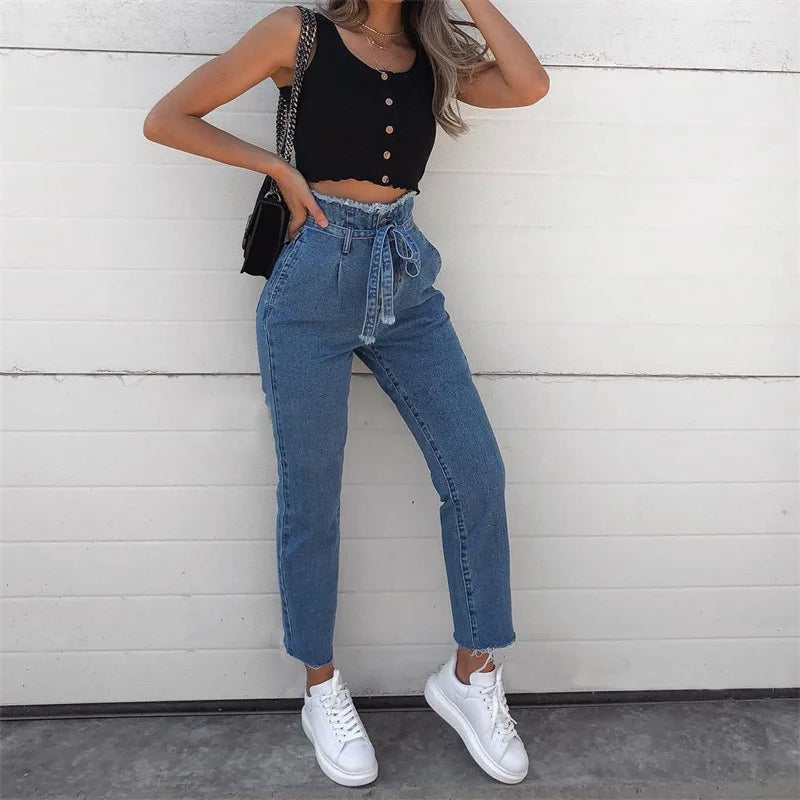 High-waisted denim pants with frayed edges, skinny legs, front and back pockets, and denim drawstring waist