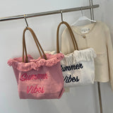 Summer beach bag made of fabric with fringes and printing "Summer vibes" and Click button to close