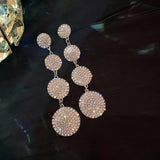 Long earrings with a circle design, fully decorated with crystals