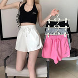 Elegant women's sports shorts in solid color, front pockets and drawstring