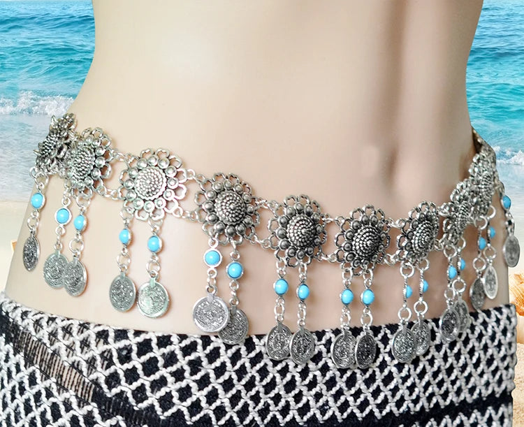 A waist belt body chain with floral shapes decorated with blue stones and dangling coins