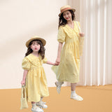 Matching summer dress for mother and daughter with a light yellow check pattern, puff midi sleeves and a wide colar