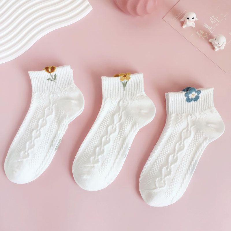A pair of short white socks with elegant rose embroidery