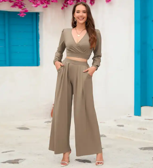 A women's two-piece suit, a blouse with a triangle chest opening and long sleeves, and pants with a distinctive waist and a wide cut.