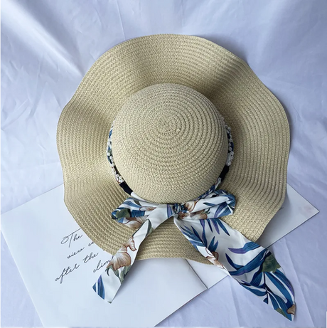 Women's summer straw hat with wavy brim and brim And a ribbon with a tree print around the circumference of the head