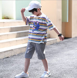 A two-piece set for a boy, a white T-shirt with contrasting stripes and a dinosaur face print , and khaki torn denim shorts with front pockets