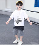 A two-piece set for boys, denim shorts in a gradient color from black to gray and a T-shirt with a writing print on the front and a large print on the back.