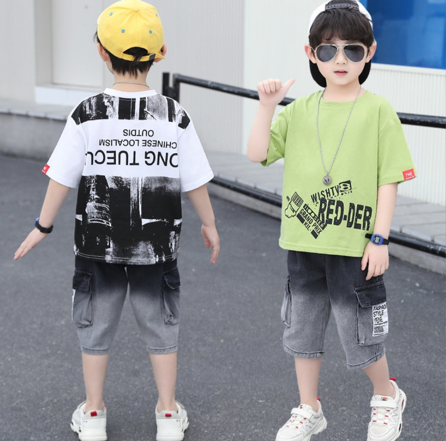 A two-piece set for boys, denim shorts in a gradient color from black to gray and a T-shirt with a writing print on the front and a large print on the back.