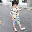 Boys' two-piece set, light-colored denim shorts with front pockets and a comic-print T-shirt