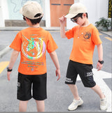 A two-piece set for a boy, black shorts with front and side pockets, and a T-shirt with a unicorn logo print on the front and back.