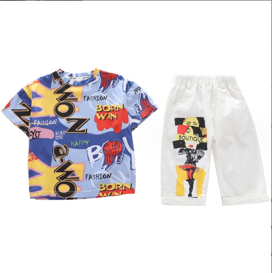 A two-piece boy's set, a T-shirt with random colors and phrases, and white shorts with a print on the front