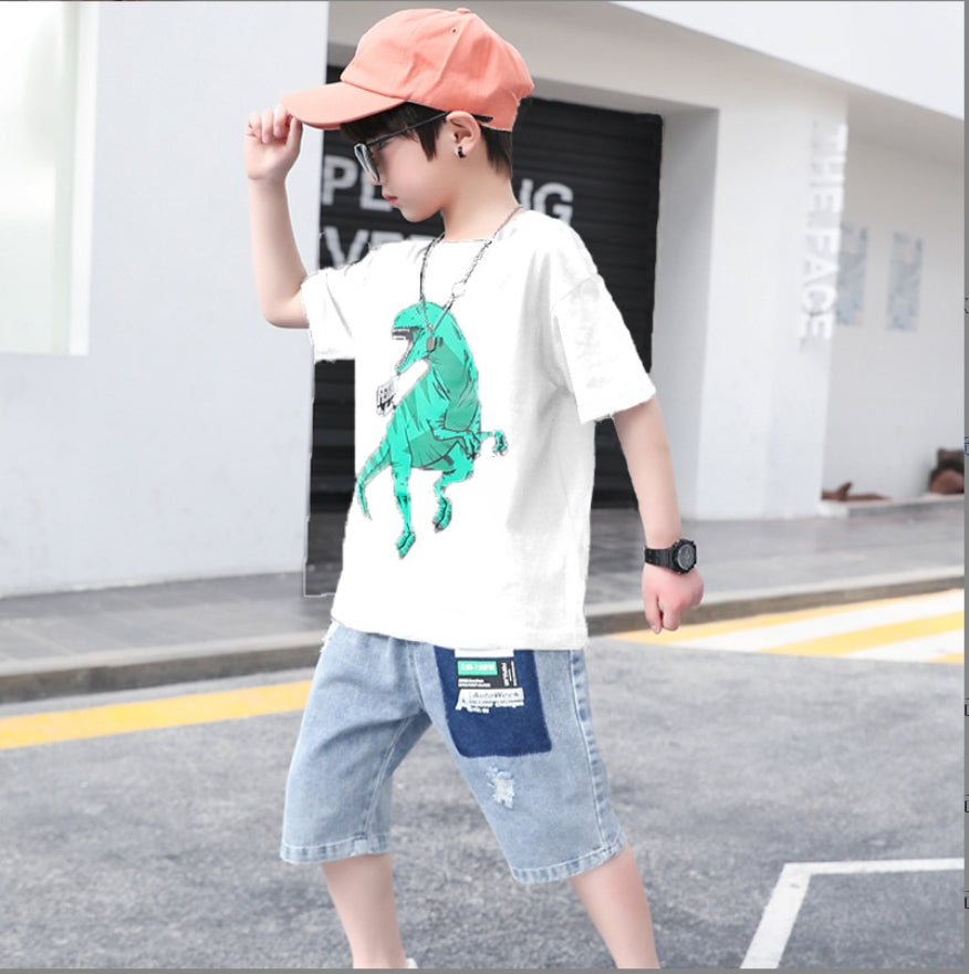 A set of two pieces, a solid color oversized T-shirt with a large dinosaur print and sky blue denim shorts with a print on the front