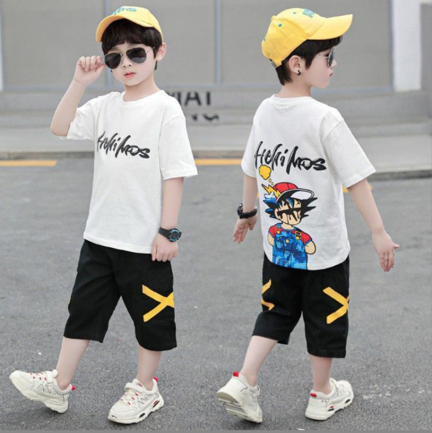 A two-piece boy's set: a wide T-shirt with a cartoon character printed on the back and writing, and long black shorts with an X sign on the sides