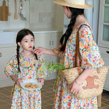 Matching long summer shirt for mother and daughter with a floral pattern and short puff sleeves