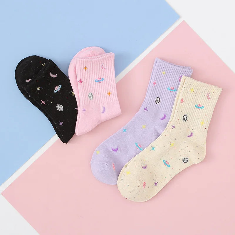 A pair of mid-length socks with stars, moon and planets design