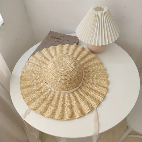 Straw hat with waves and bow