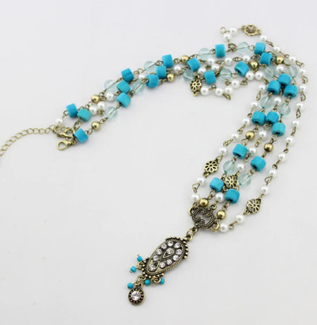 Head bracelet with sky blue wooden beads, pearl grains, and a dangling front pendant