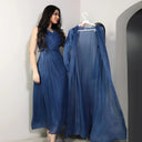 A two-piece set of a long, solid-colored, sleeveless dress and an elegant abaya in the same color