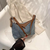 Brown denim and leather bag with a silver chain and zipper closure