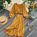 Women's solid color two-piece set: a button-front shirt with long sleeves and elasticated back, and a long skirt with a button-front