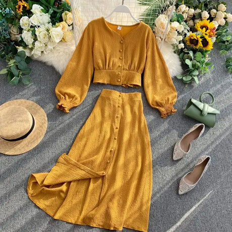 Women's solid color two-piece set: a button-front shirt with long sleeves and elasticated back, and a long skirt with a button-front