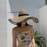 Women's summer straw hat with a wide brim and a transparent tip in black A black ribbon goes around the head