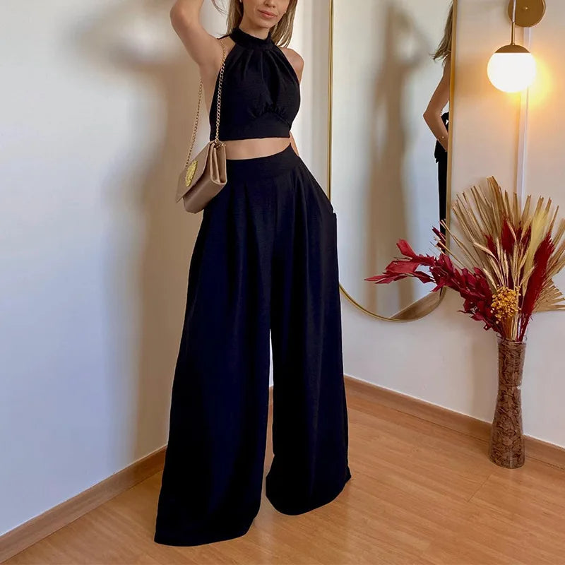 An elegant two-piece set for women, a sleeveless crop top and wide, high-waisted pants in a solid color