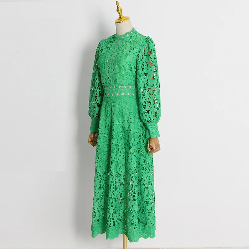 Long cloche dress with green cut-out fabric, long sleeves, puffed shoulders, and a closed round neck