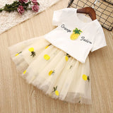 A girls' two-piece set, a white T-shirt and a fluffy tulle skirt with pineapple patterns