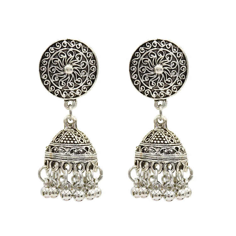 Bohemian style silver colored earrings with a circle shape, a small dome, and small hanging bells