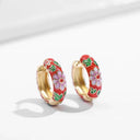 A pair of hoop earrings with floral design