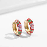 A pair of hoop earrings with floral design