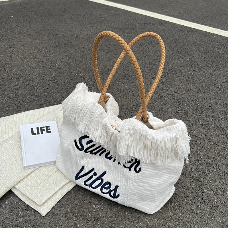 حقيبة شاطئ صيفية مصنوعة من القماش مع  قطع كشكشة وطباعة " Summer vibes " .وزر إغلاق