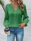 A practical and elegant women's shirt in a solid color with longitudinal stripes and long sleeves that end with ruffles