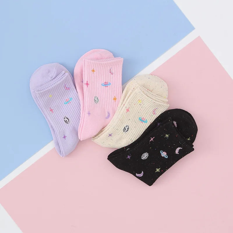 A pair of mid-length socks with stars, moon and planets design