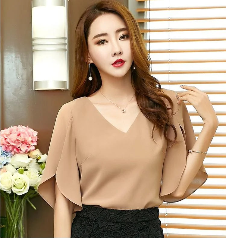 Elegant women's shirt in solid color, with short open sleeves and a triangle back opening