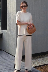 A two-piece autumn set with wide pants and an oversize shirt in a solid color with white borders, with short or long sleeves