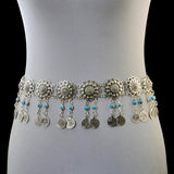 A waist belt body chain with floral shapes decorated with blue stones and dangling coins