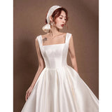 Long satin cloche dress with a square neckline A square back opening with a large bow at the back