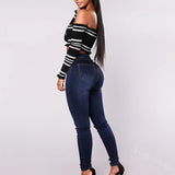 Skinny dark denim pants with a high waist and eight front buttons neatly arranged