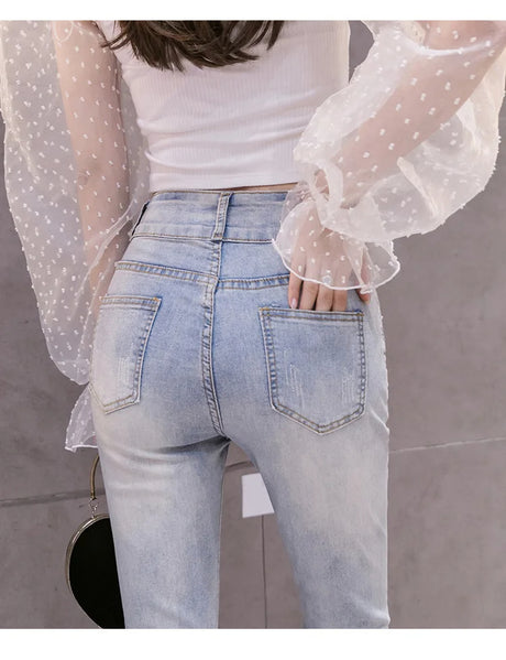 Fashionable high-waist jeans with beaded detailing, fringe trim and random hem