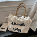 Summer beach bag made of fabric with fringes and printing "Summer vibes" and Click button to close