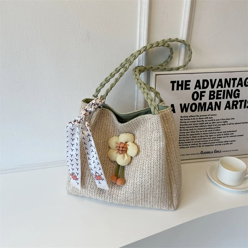 A summer shoulder bag decorated with a rose and a braided shoulder strap