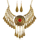 Arabic-style set: a necklace with a large circle and dangling tears, with teardrop-shaped earrings in gold or silver color