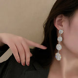 Long earrings with a circle design, fully decorated with crystals
