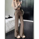 Women's pants with a distinctive side button, wide straight leg and high waist