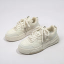 Women's casual sneakers in white with overlapping colored stripes and a front lace-up